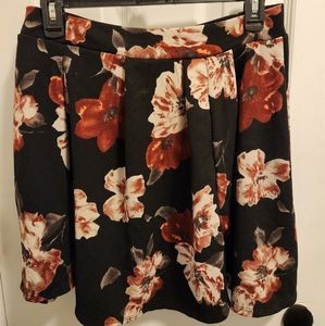 Charlotte Russe size large black skirt with red floral pattern.